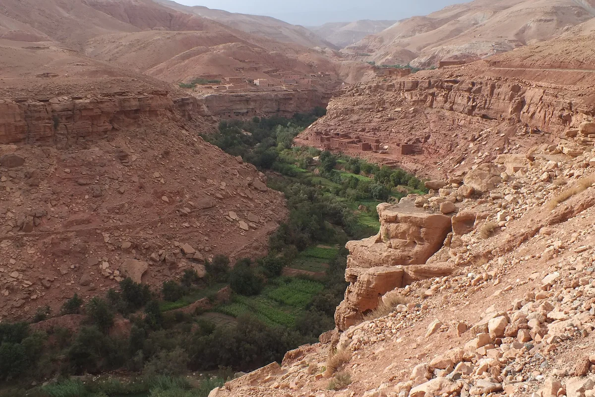 Green fields winding through the rocky Ounila Valley